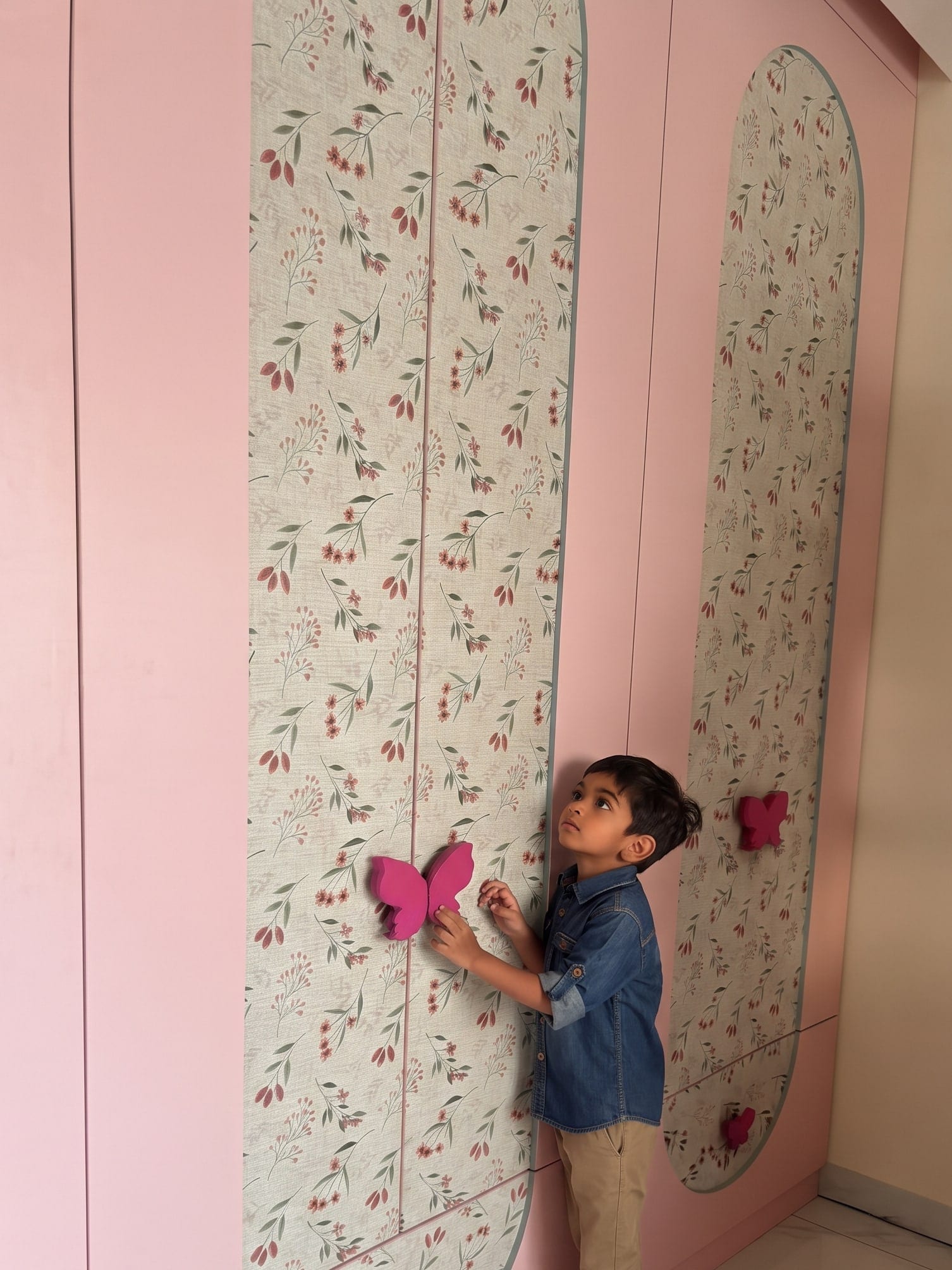 Children’s room wardrobe in pink with floral inlay panels and butterfly handles
