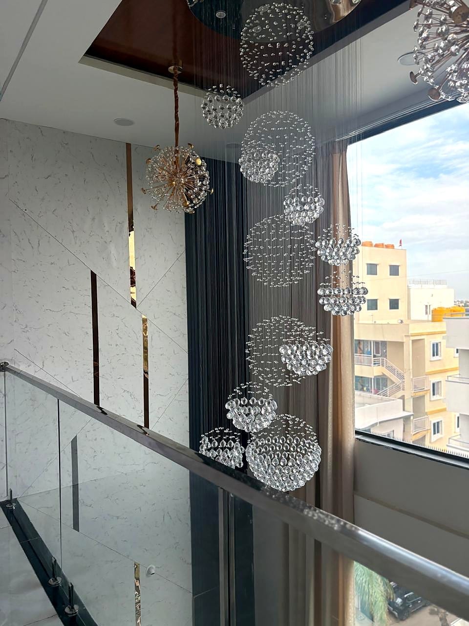 Double-height chandelier + balcony