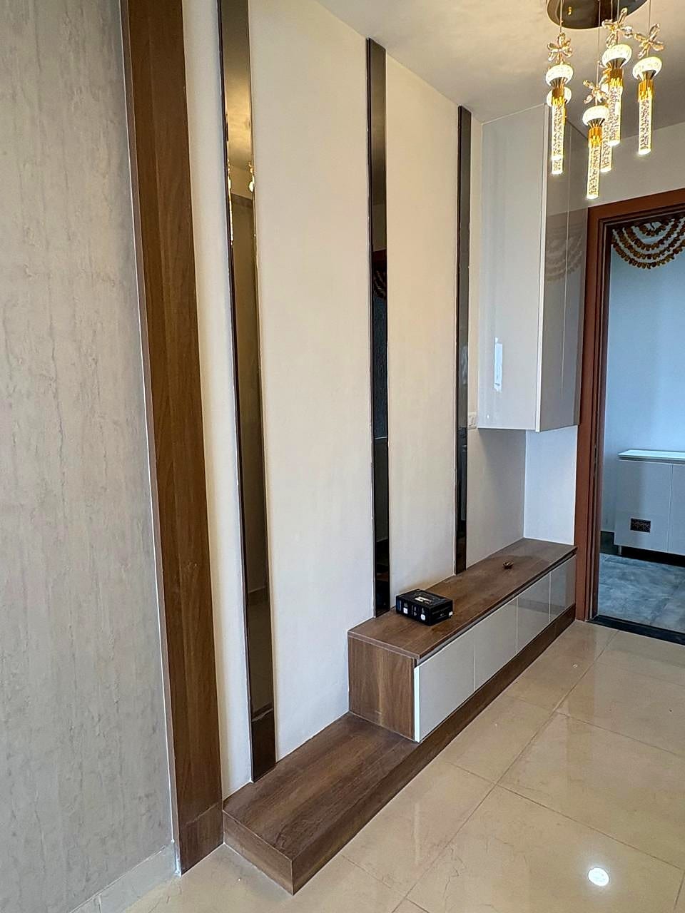 An empty foyer with a console and a fluted feature wall