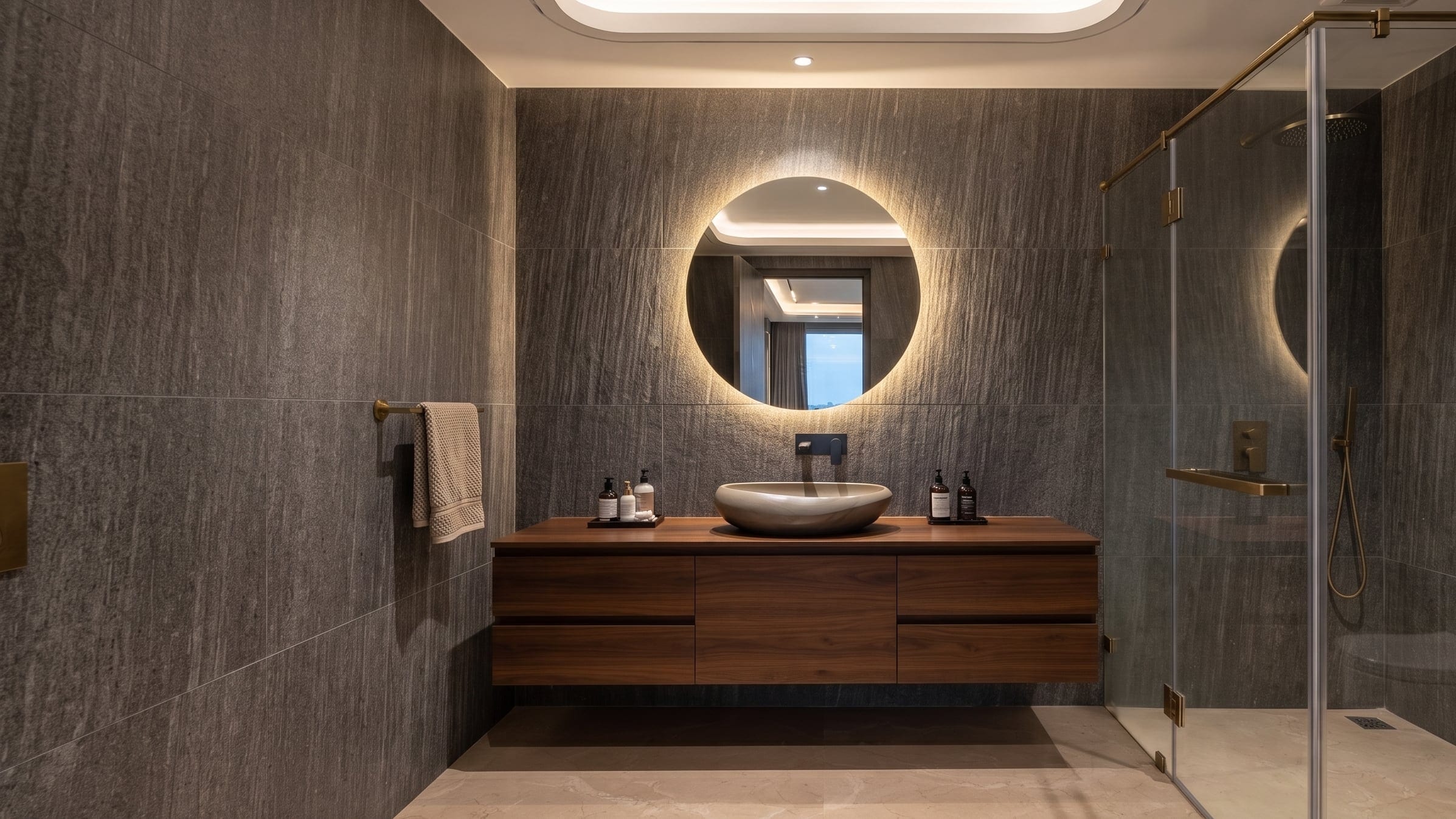 A bathroom vanity with a fluted panel, stone counter and a round mirror